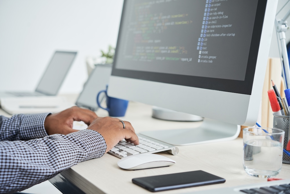 a man working of the computer setting up a program