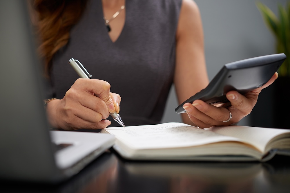 a woman working on some bookkeeping paper work